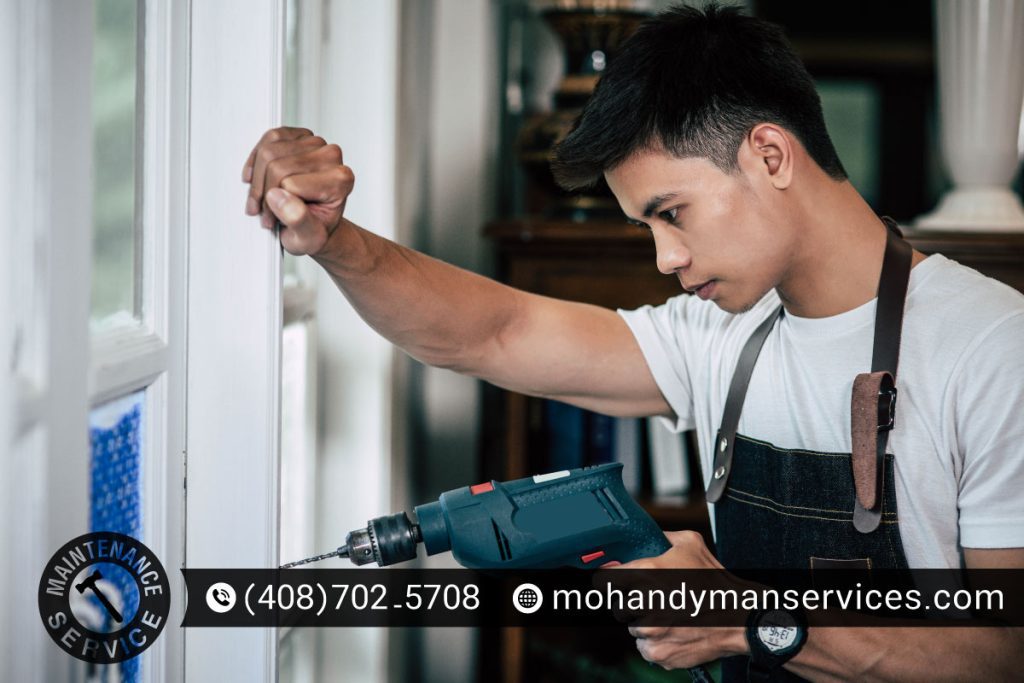 Close-up of a professional carefully repairing a window frame in a Mountain View home.